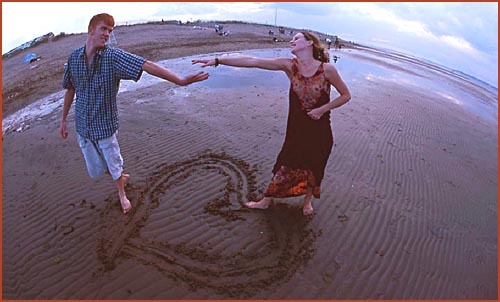 Teenage Love Quotes: Young happy couple at the beach holding hands.