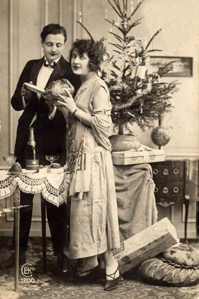 Old vintage photo couple in love at Christmas tree