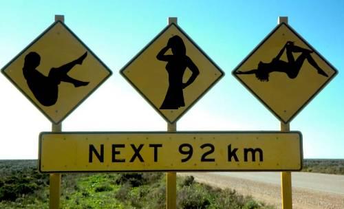 Hilarious signs and funny road sign: Really funny picture of three strippers. Strippers after 92 km