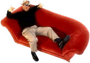 Inspirational love stories: Happy man relaxing in a red sofa.