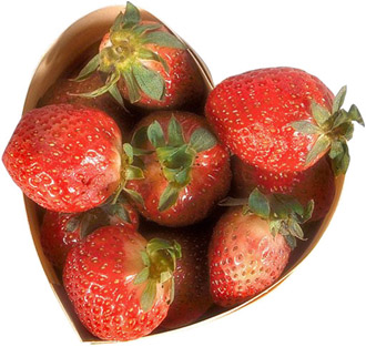 Love symbolics: Strawberries in love heart shaped bowl