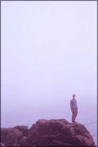 Man on cliff point by the sea.