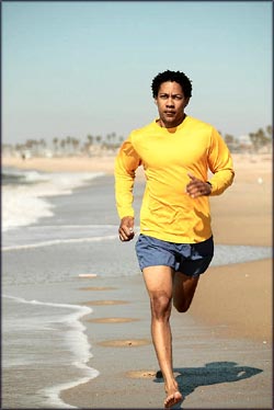 Motivation: man running on the beach by the water.