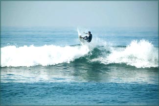 The power of believing you can do it: Man surfing on big wave.