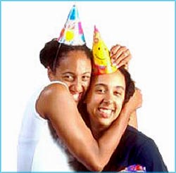 Man and woman with happy New Year hats giving each other a hug.