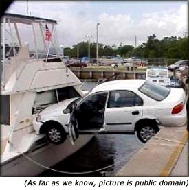 Funny picture of car accident. Car crashing into yacht.