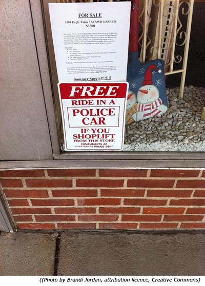 Funny police signs: Free ride in a police car if you shoplift from this store!