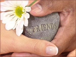 Thank you quotes: Two hands holding a stone with friends written on it and flower next to it.