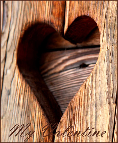 Picure of heart carved in to a wooden door.