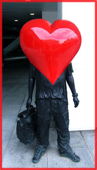 Funny Valentine Poems: Man in black with big red plastic heart as a head.