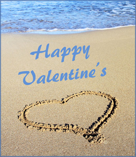 Modern Valentines Day card: heart drawn in the sand near the water.