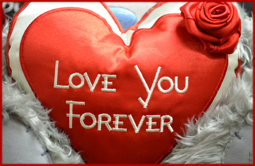 Valentine Pictures: Heart shaped pillow with red rose.