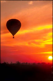 A Valentine trip in a hot air balloon in the orange sunset.