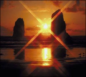 Quotes about belief: Beautiful orange sunset by the beach with the setting sun between two giant rocks.