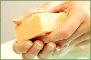 Orange soap bar in woman's hands.
