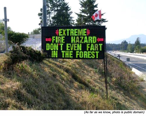 Funny and silly signs: A funny road sign saying: Extreme fire hazard. Don't even fart in the forest!