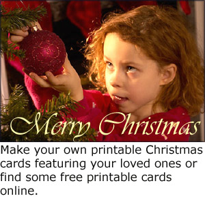 Homemade photo Christmas greeting card: Make your own printable christmas cards: Little girl hanging up Christmas decorations on Christmas tree.