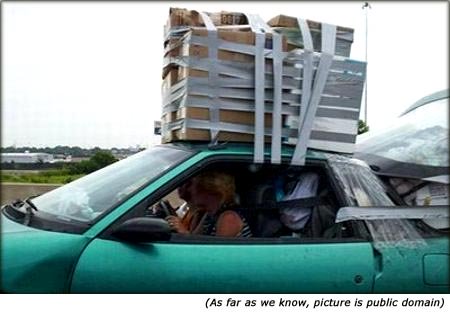 Quotes on car insurance: Funny picture of car with very big luggage on the roof.