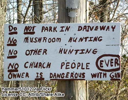 Funny warning sign: Do not park in driveway! No mushroom hunting! No other hunting! No church people ever! Owner is dangerous with gun!