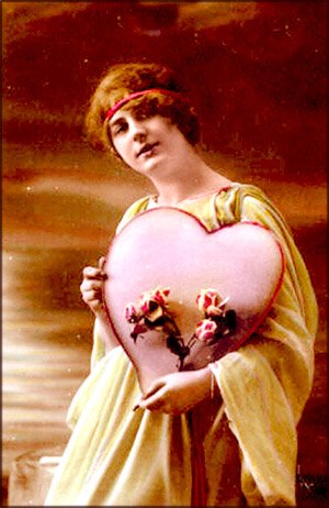 Old photo of woman with head band holding a heart and pink flowers. Beautiful Valentines Day pictures.