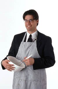 Valentine idea: man in suit and apron cooking, stirring in a bowl.