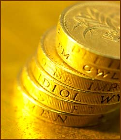 Facts about Newton and coins: Photo of stack of golden coins.